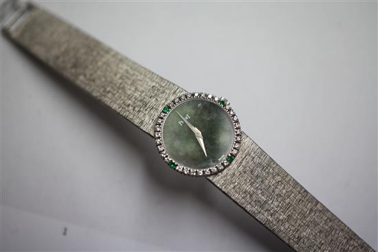 A ladys 18ct white gold Piaget manual wind wrist watch with diamond and emerald set bezel and jade dial,